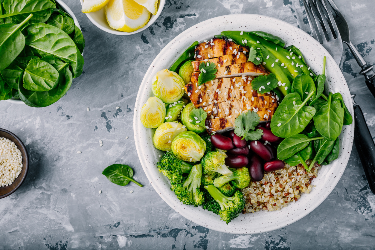 Buddha Bowl healthy dinner with grilled chicken, quinoa, spinach, avocado, Brussels sprouts, broccoli, red beans, sesame seeds evening dinner food sleep