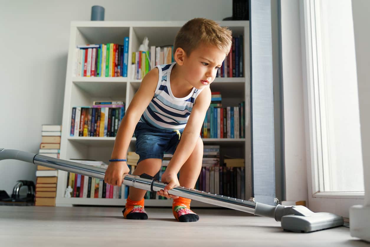 child vacuuming household chores