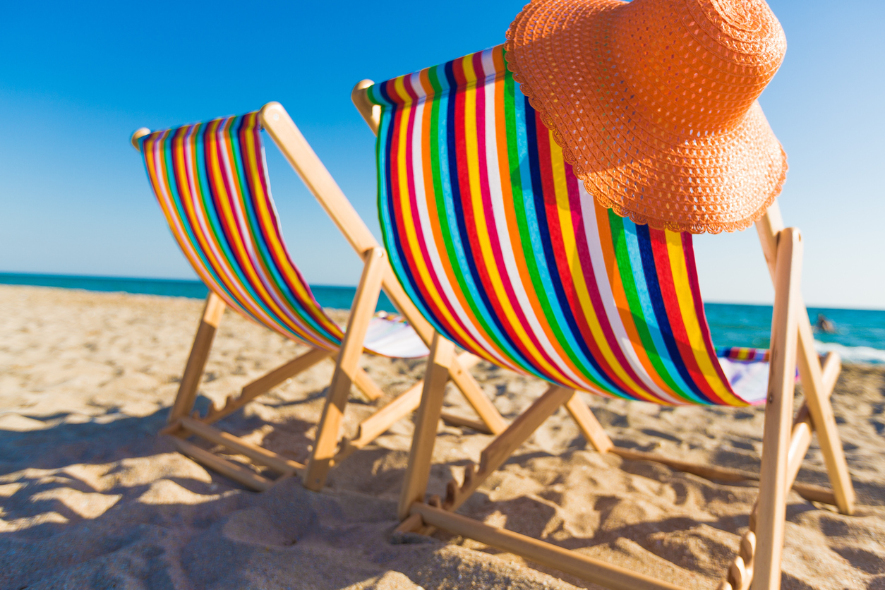 deckchairs fine sand beach sea beach equipment summer sun hat