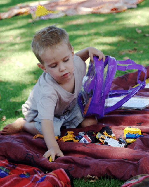 child putting away his toys