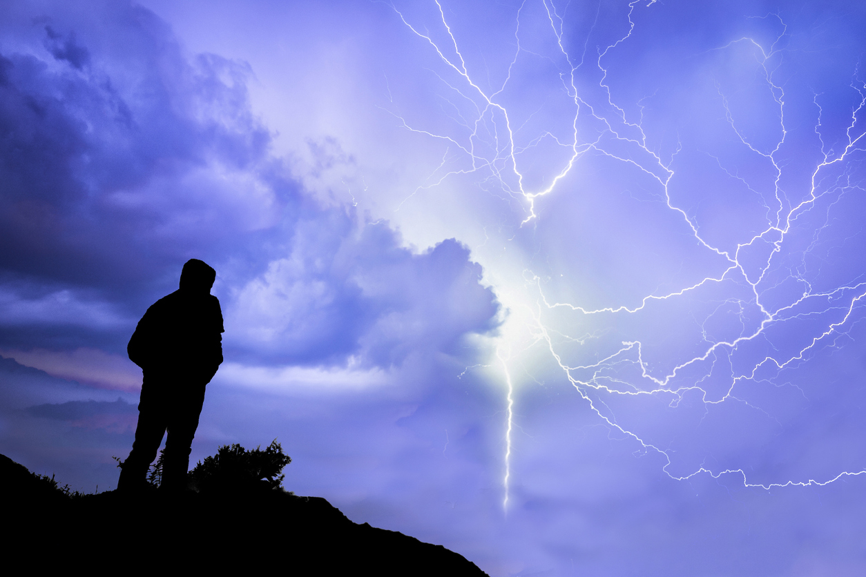 man in front of the storm lightning lightning