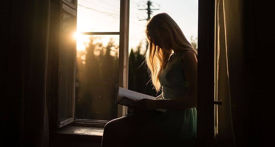 woman reading window