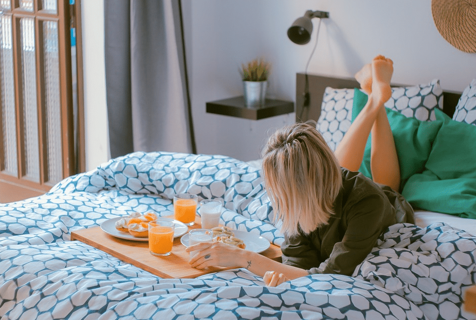 woman breakfast bed morning orange juice