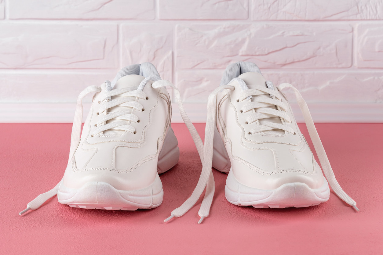 Pair of white sneakers with white laces